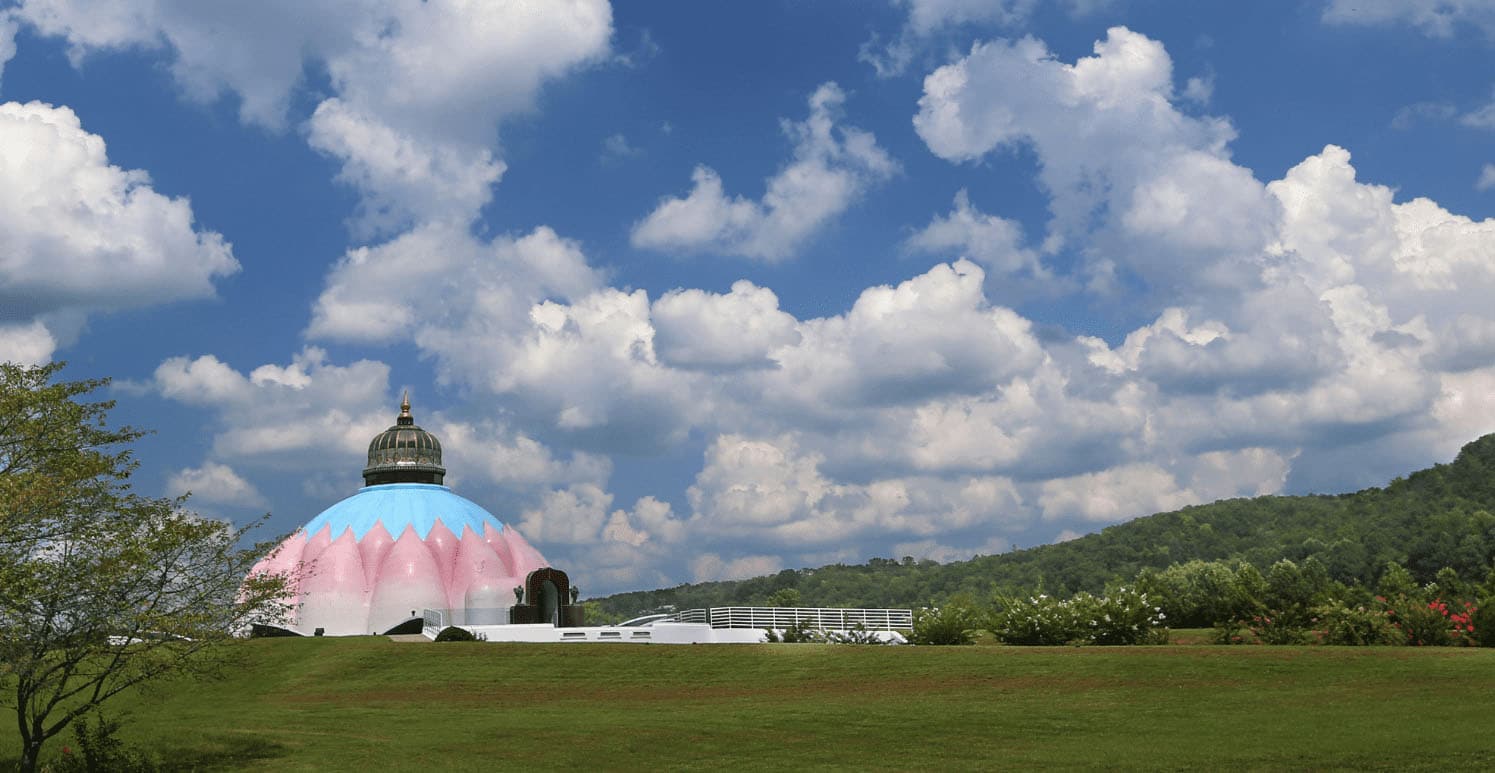 Pink and blue Light of Truth Universal shrine on a hilltop with blu sky